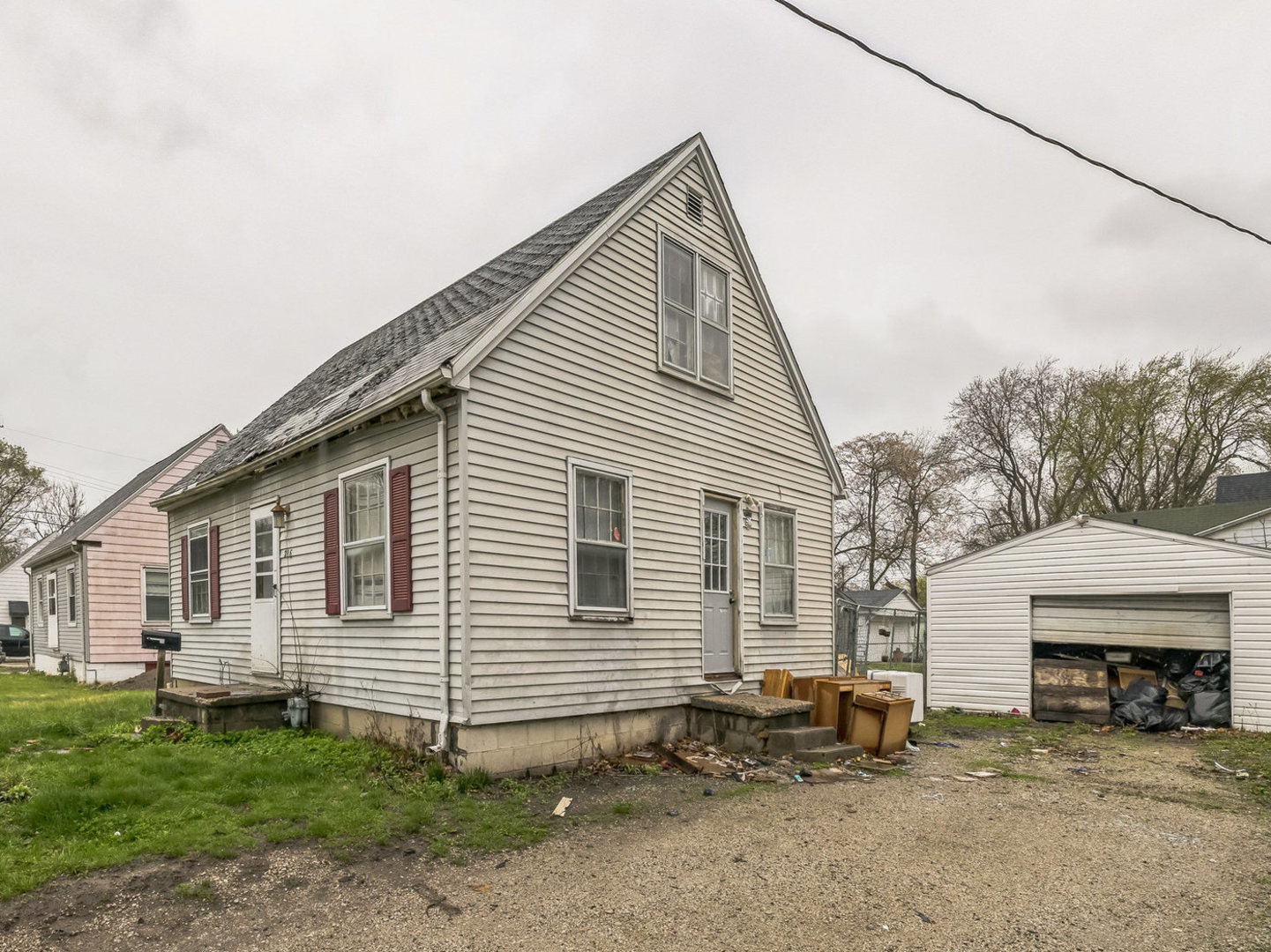 a view of a house with a yard and sitting area