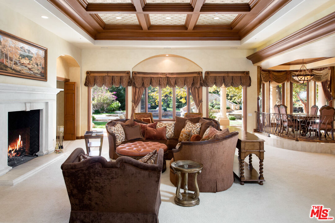 9269 Stockton Road Moorpark, CA 93021 - Photo 11 of 46 a living room with furniture a fireplace and a ceiling fan