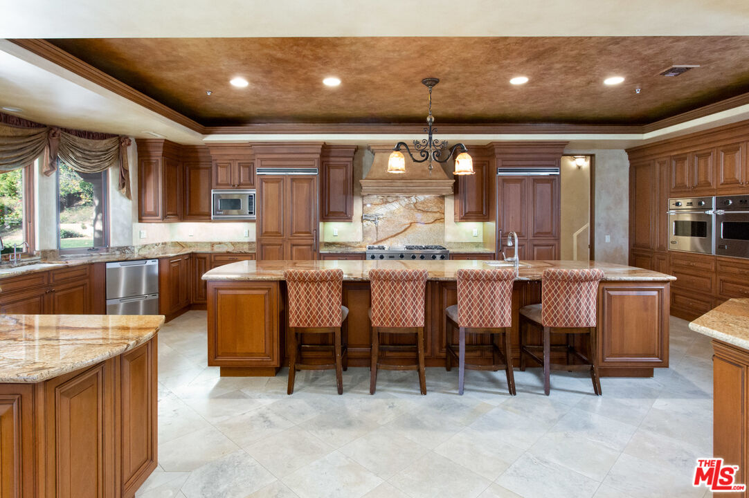 9269 Stockton Road Moorpark, CA 93021 - Photo 14 of 46 a large kitchen with lots of counter space and furniture