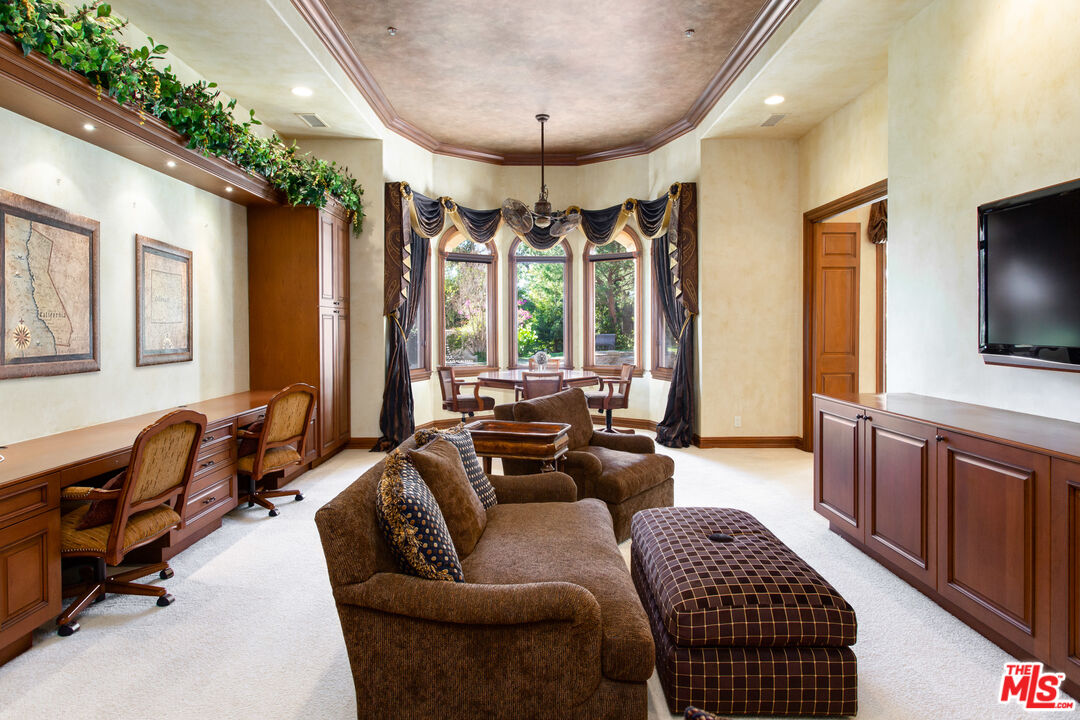9269 Stockton Road Moorpark, CA 93021 - Photo 15 of 46 a living room with furniture a flat screen tv and a large window