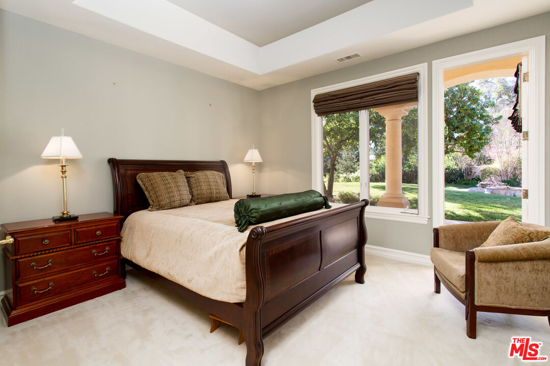 9269 Stockton Road Moorpark, CA 93021 - Photo 21 of 46 a bedroom with a bed and a couch next to a window