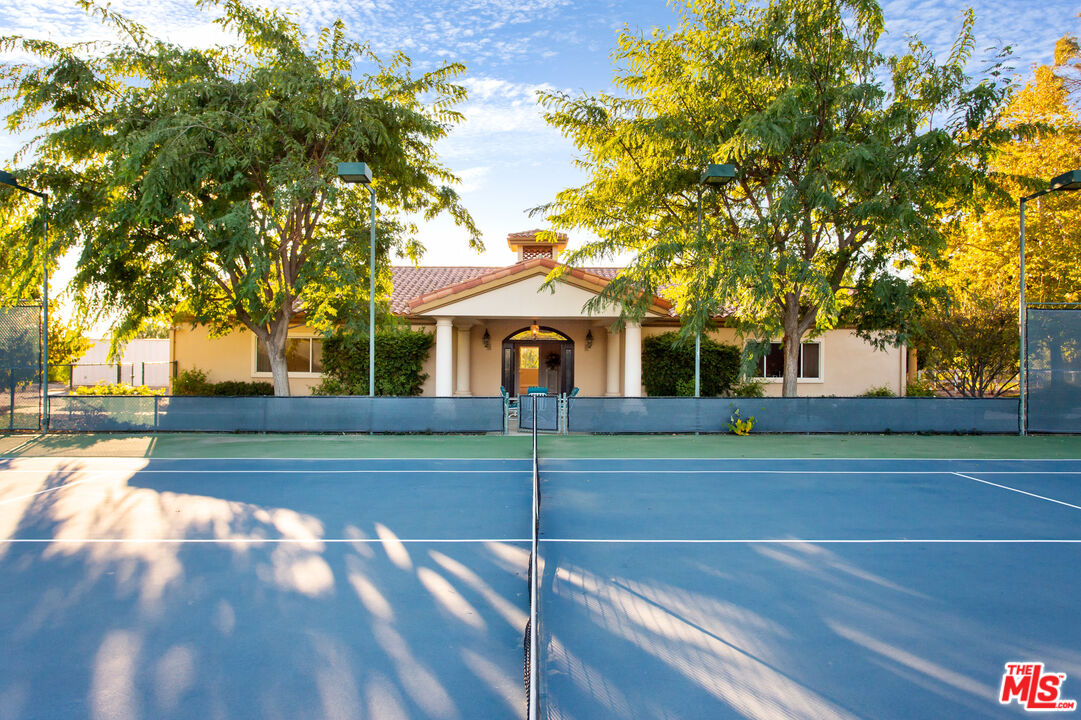 9269 Stockton Road Moorpark, CA 93021 - Photo 40 of 46 a view of a white house next to a yard with big trees