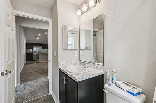 a bathroom with a sink vanity and a mirror