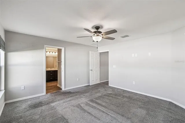 an empty room with fan and a ceiling fan