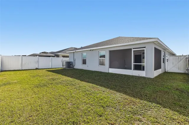 a view of a house with a backyard