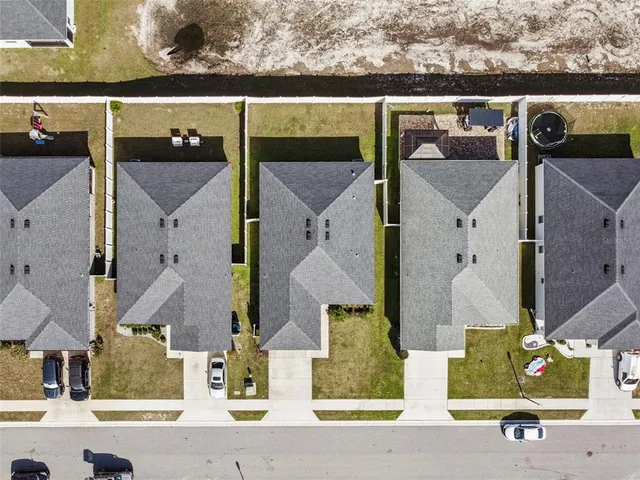 an aerial view of houses with outdoor space