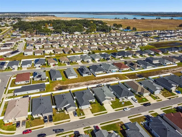 an aerial view of residential building and lake