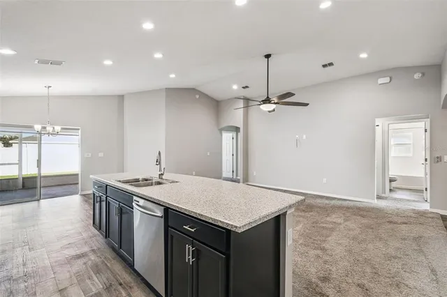 a kitchen with granite countertop a stove and a sink