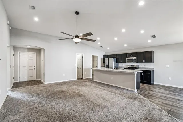 a large kitchen with stainless steel appliances kitchen island a large island in the center