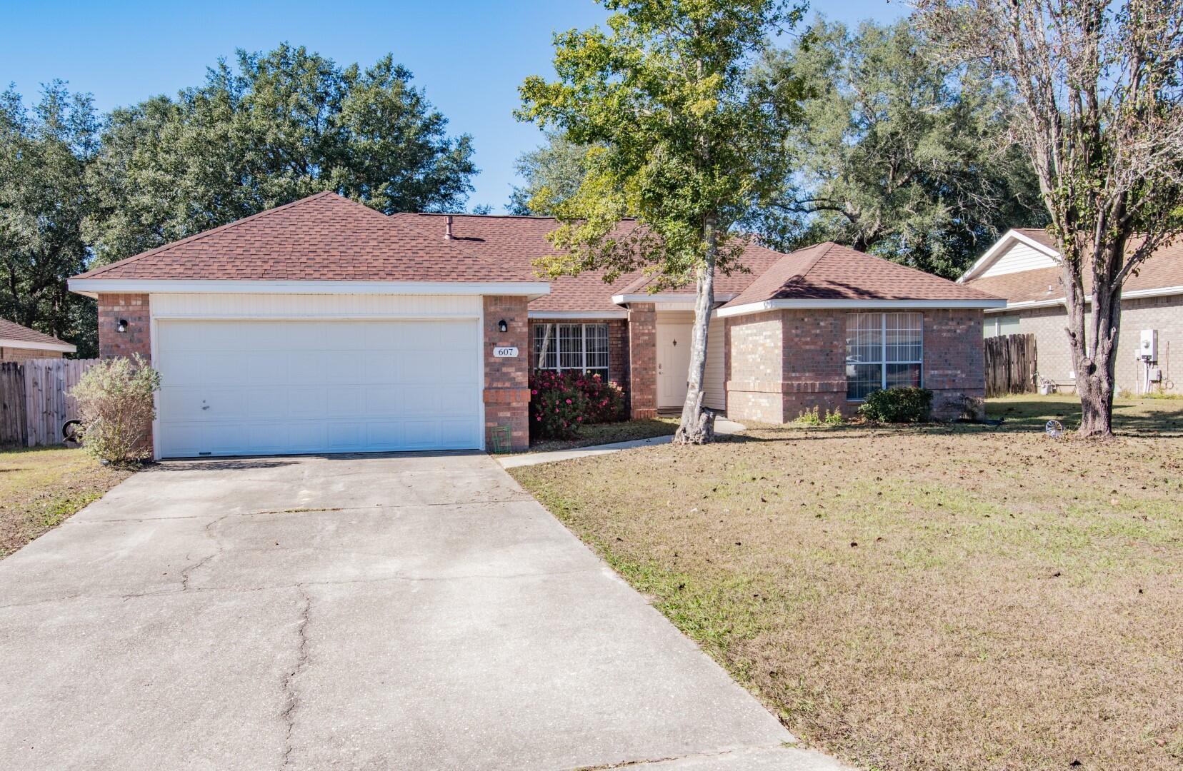 607 Risen Star Drive Crestview, FL 32539 - Photo 2 of 35 a front view of a house with a yard and covered with snow