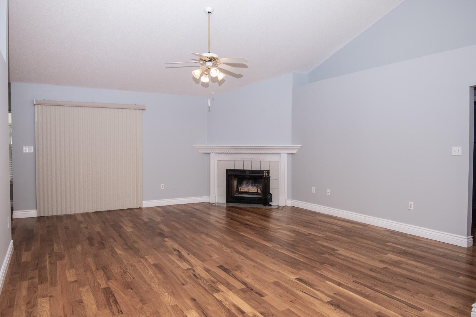 607 Risen Star Drive Crestview, FL 32539 - Photo 4 of 35 a view of an empty room with wooden floor and a fireplace