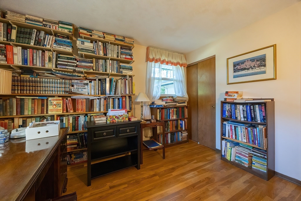 21 Trinity Drive Milford, MA 01757 - Photo 21 of 38 a living room with a book shelf and a book shelf