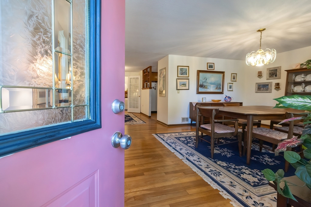 21 Trinity Drive Milford, MA 01757 - Photo 4 of 38 a living room with furniture a rug and a chandelier