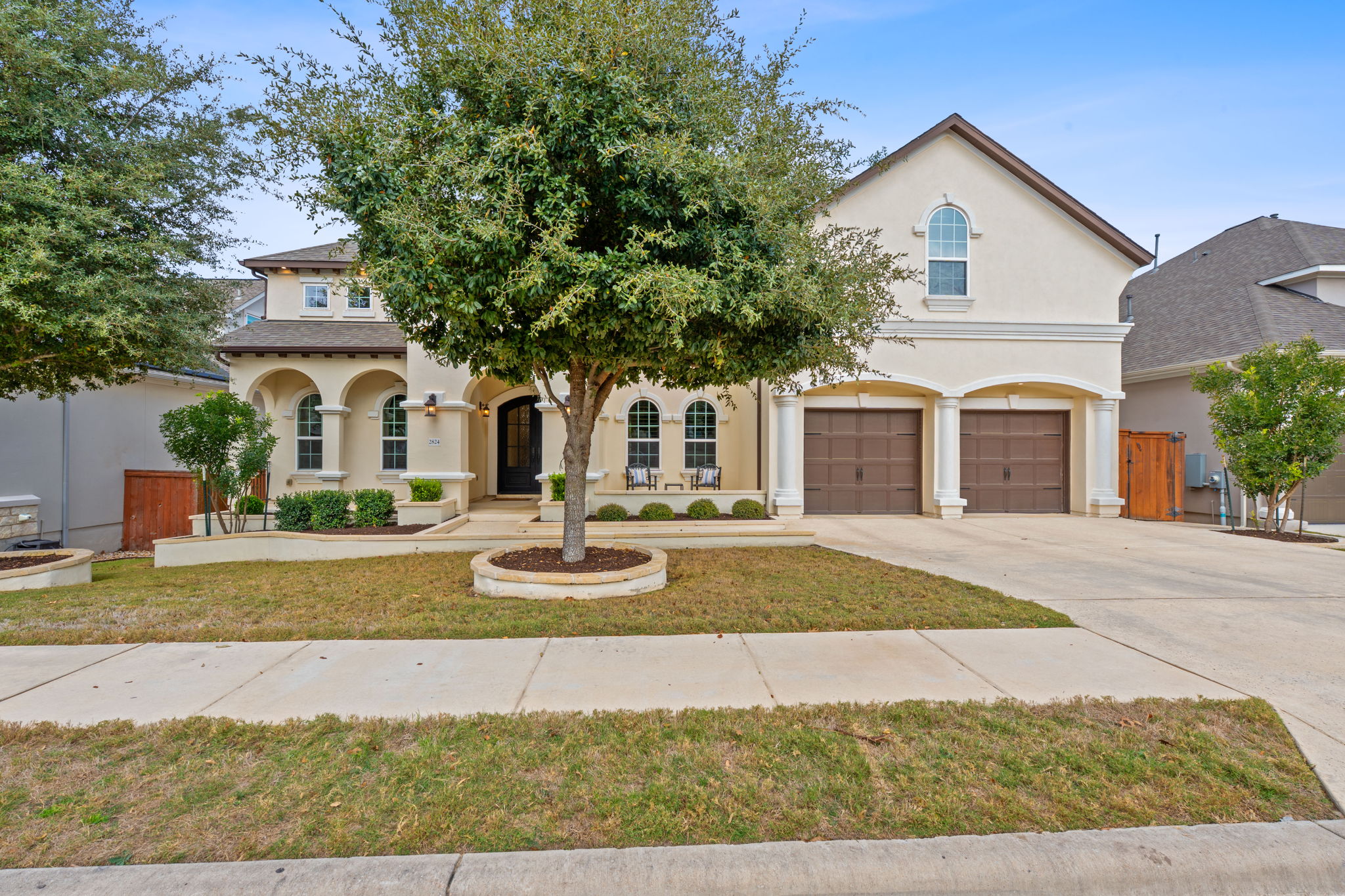 2824 Wedgescale Pass Leander, TX 78641 - Photo 7 of 40 The Mediterranean-inspired facade and manicured landscaping create a striking first impression