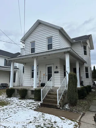 a front view of a house with wooden stairs