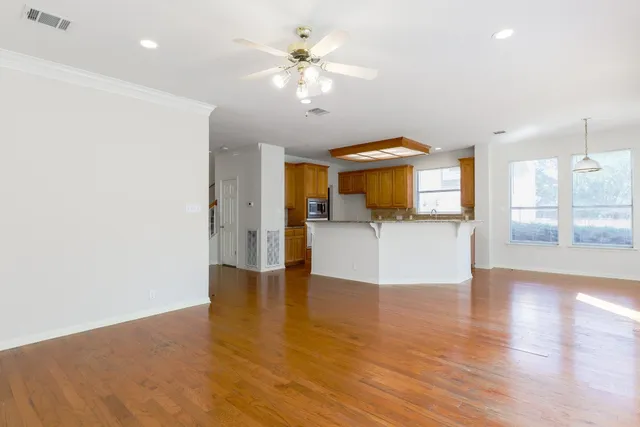 a view of a kitchen with wooden floor and a chandelier