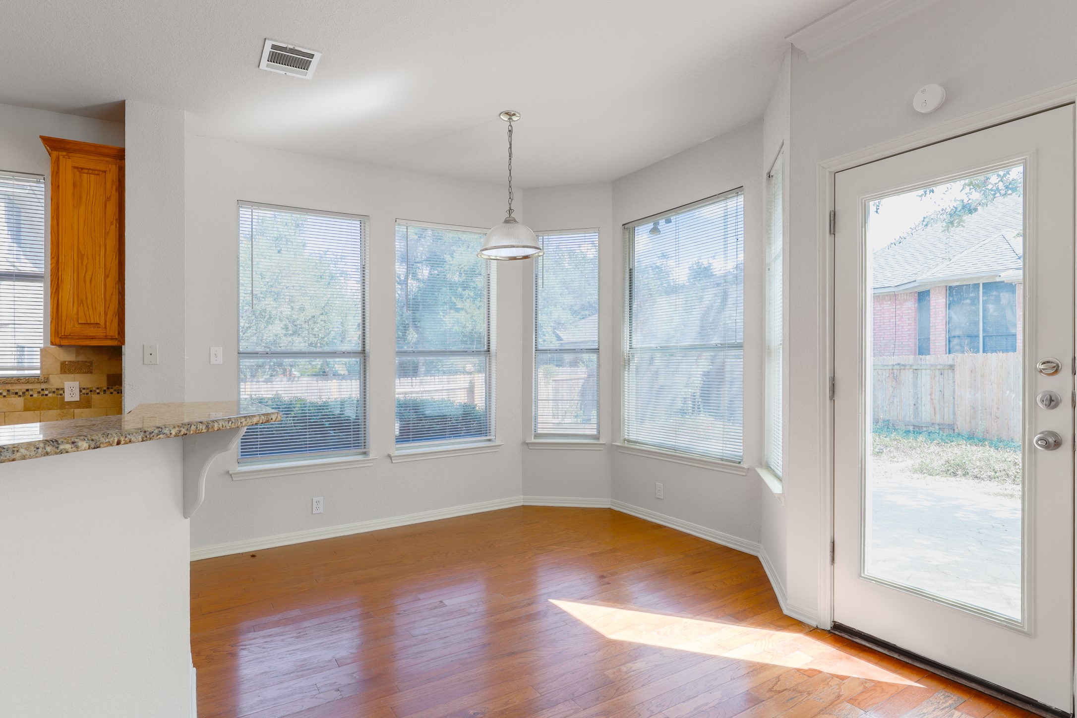 10225 Open Gate Drive Austin, TX 78726 - Photo 12 of 34 a view of an empty room with a window and wooden floor