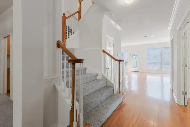 a view of entryway and hall with wooden floor