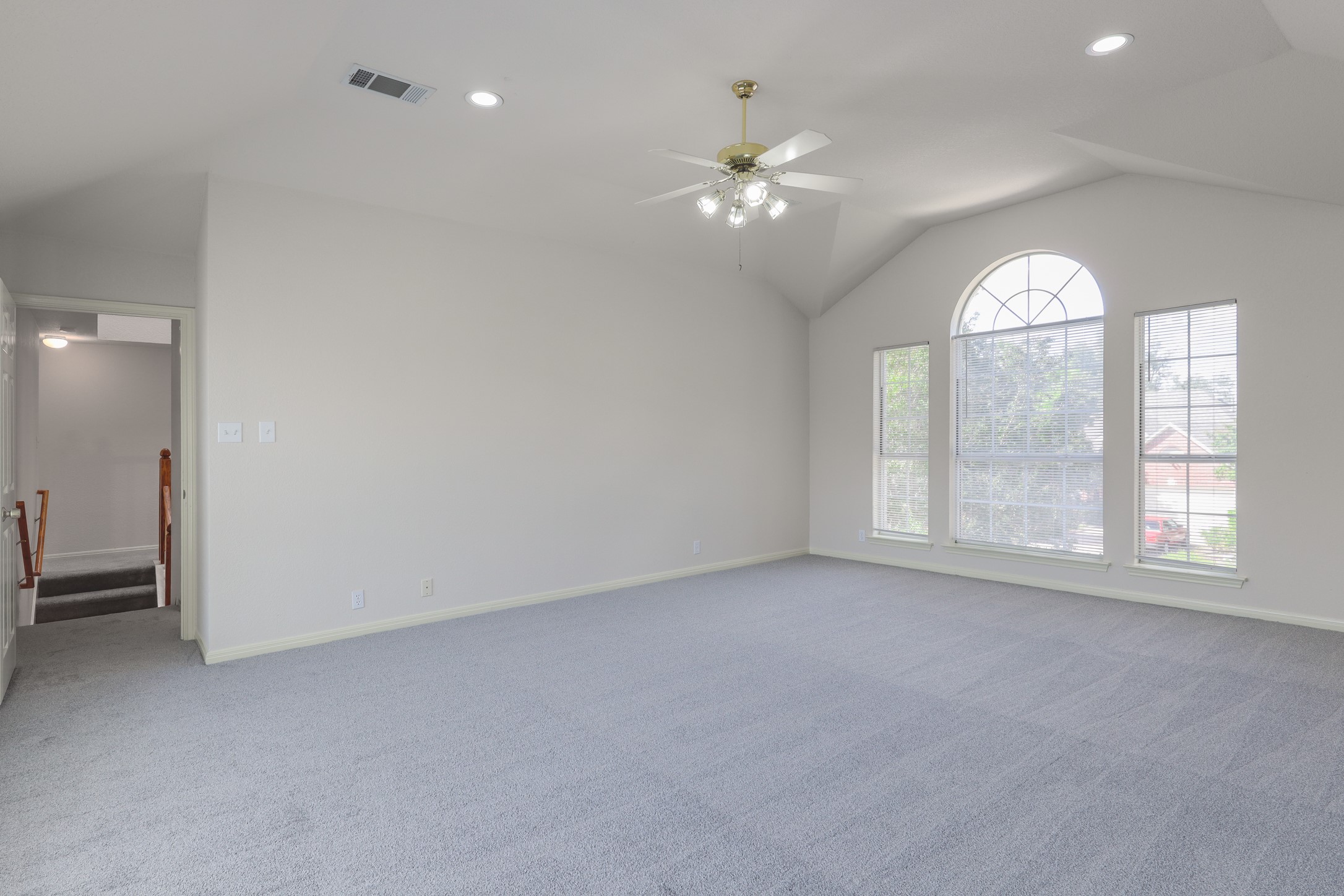 10225 Open Gate Drive Austin, TX 78726 - Photo 18 of 34 an empty room with chandelier fan and windows