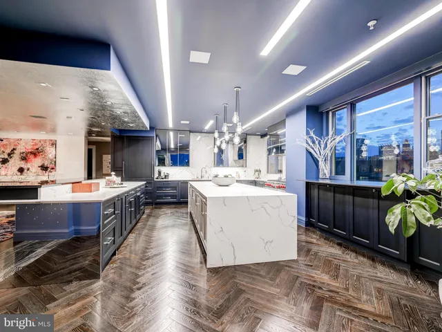 a kitchen with lots of wooden furniture a sink and chairs