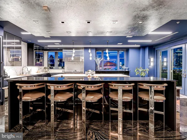 a view of a hallway with wooden floor and windows