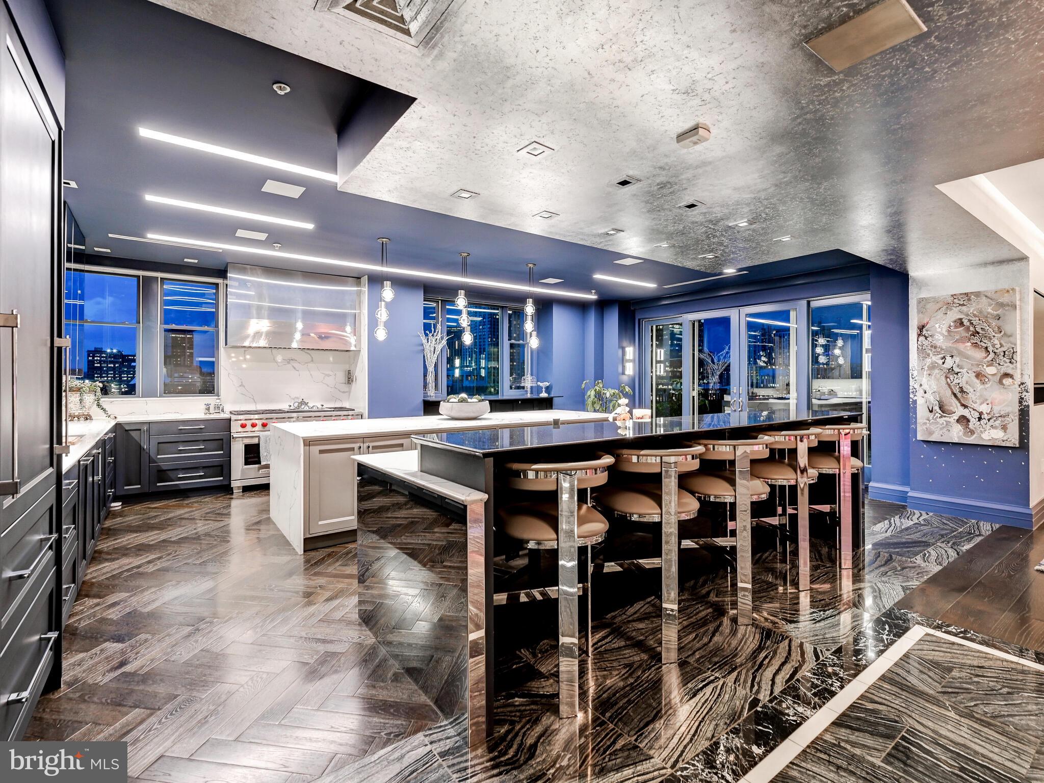801 Key Highway, Unit P54 Baltimore, MD 21230 - Photo 27 of 81 a kitchen with lots of wooden furniture a sink and chairs