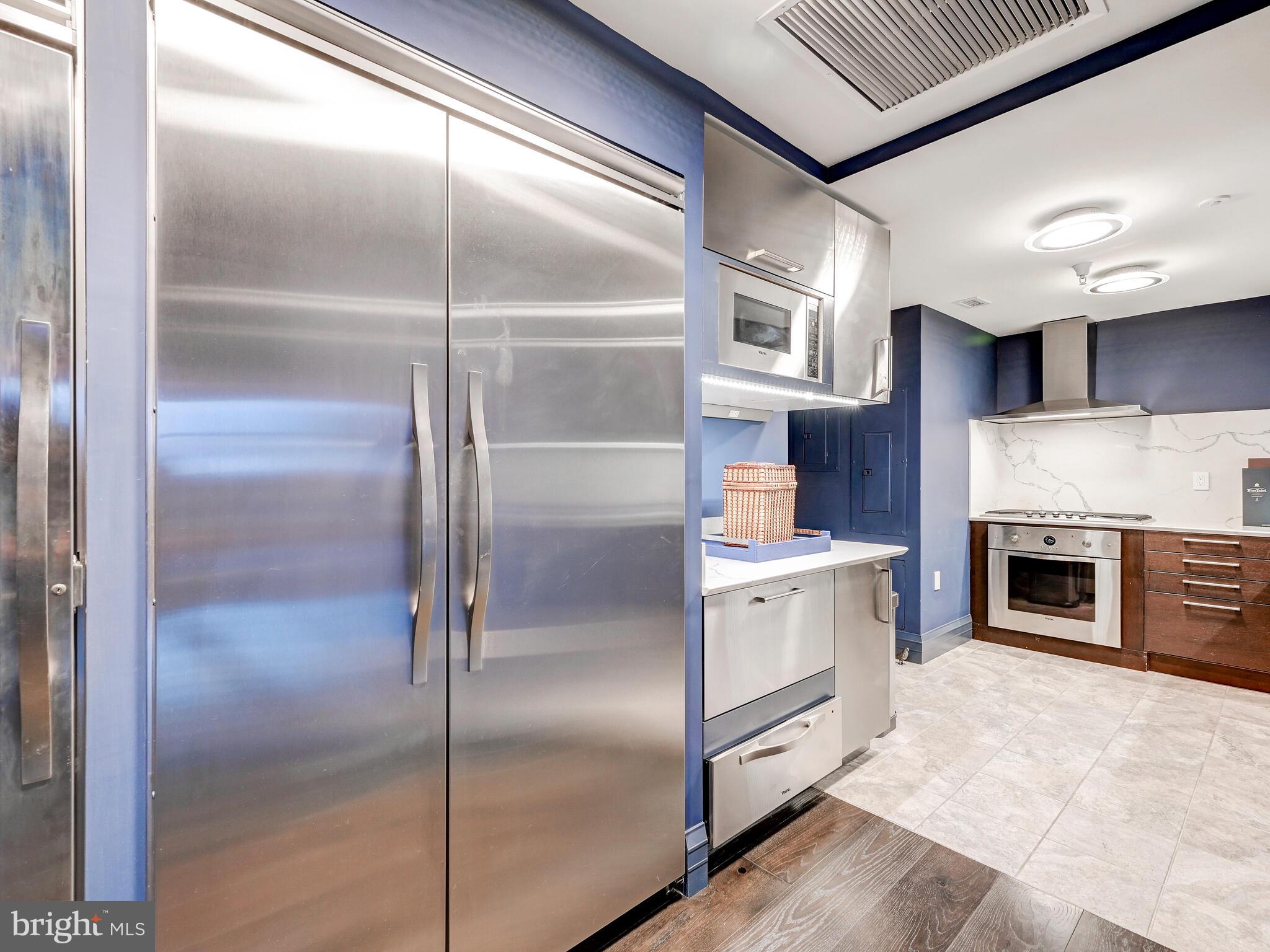 801 Key Highway, Unit P54 Baltimore, MD 21230 - Photo 28 of 81 a kitchen with white cabinets and stainless steel appliances