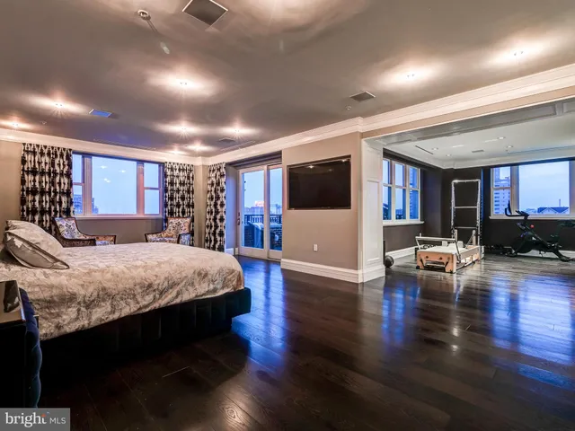a bedroom with a large bed and a chandelier