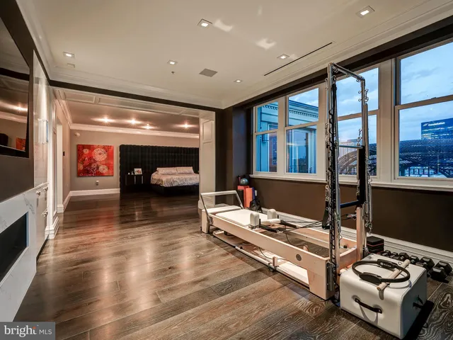 a spacious bedroom with a large bed and a chandelier