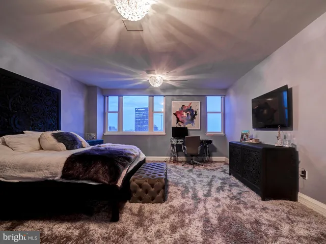 a view of hall way with furniture and chandelier