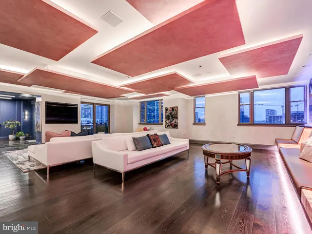 a living room with furniture window and wooden floor