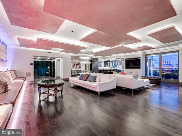 a living room with furniture and a chandelier