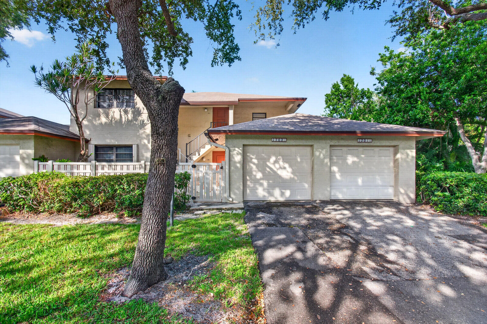 3951 Northeast 19th Road, Unit 1701 Pompano Beach, FL 33064 - Photo 68 of 82 a front view of a house with a garden