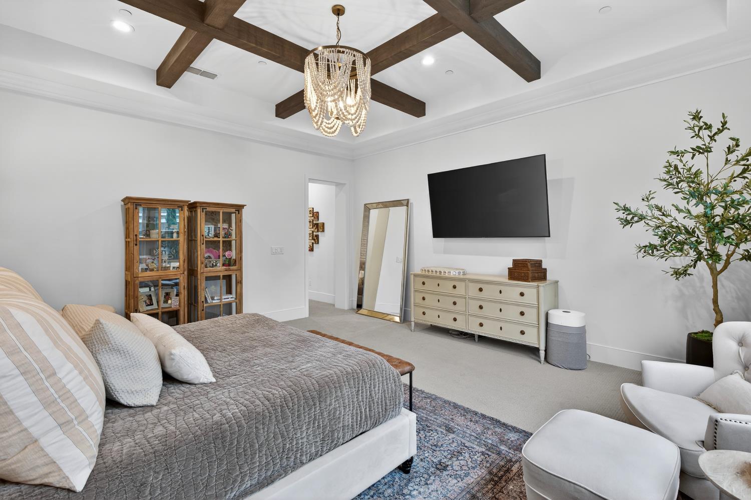 61 Secret Court Lodi, CA 95242 - Photo 31 of 79 a bedroom with a bed a couch and a flat screen tv