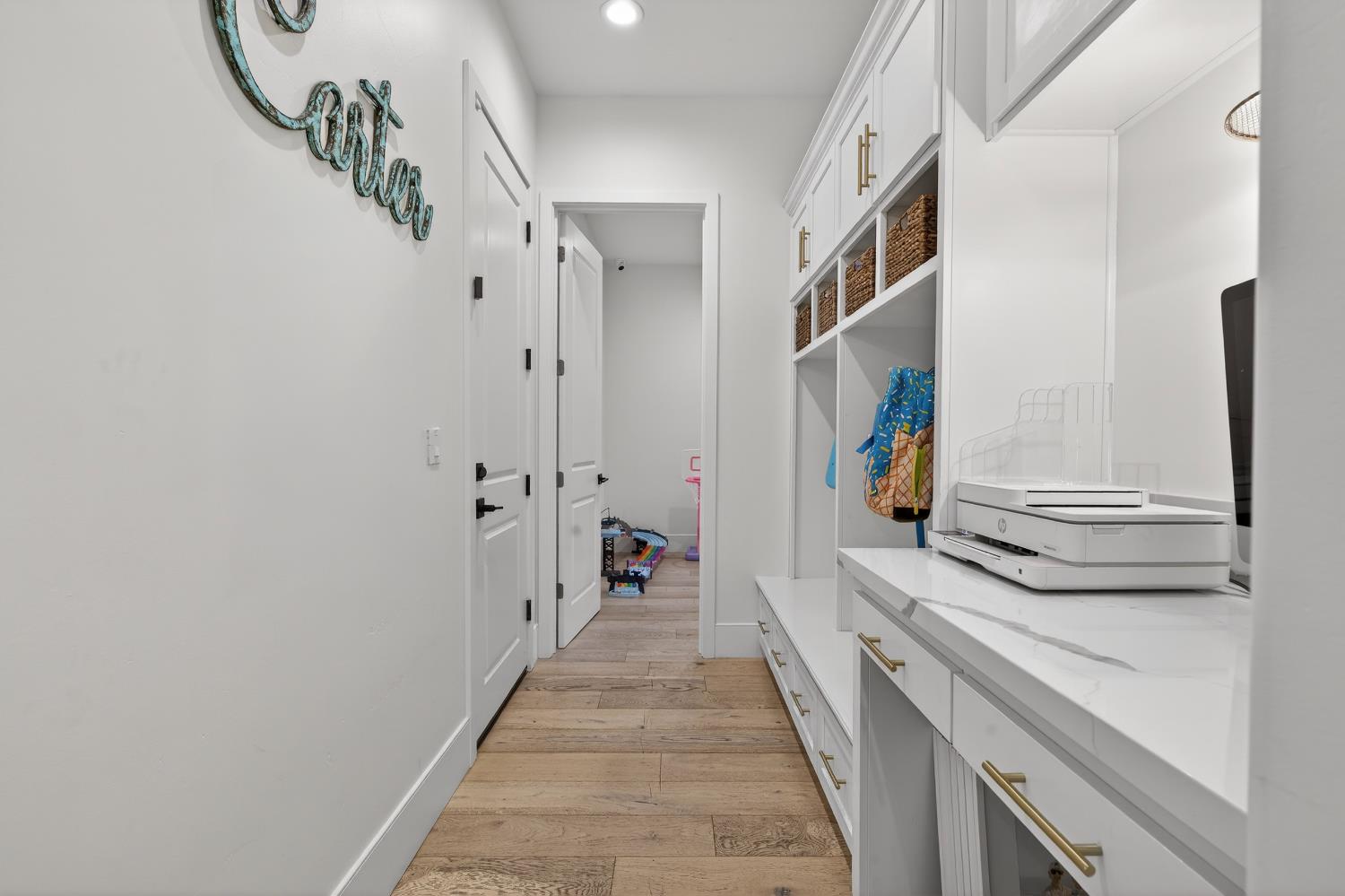 61 Secret Court Lodi, CA 95242 - Photo 41 of 79 a hallway with white cabinets and dryer