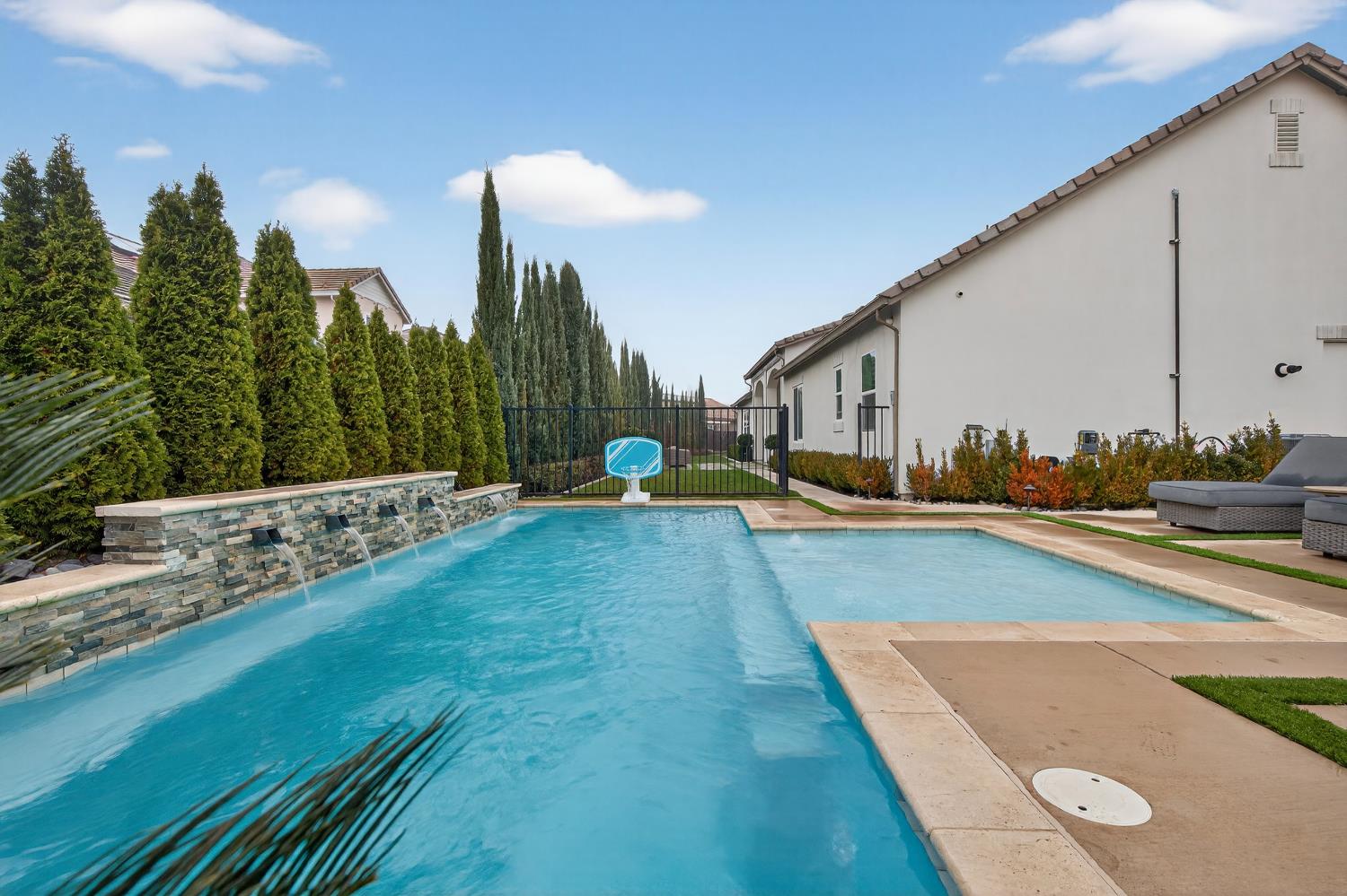 61 Secret Court Lodi, CA 95242 - Photo 67 of 79 a view of a swimming pool with a lounge chairs