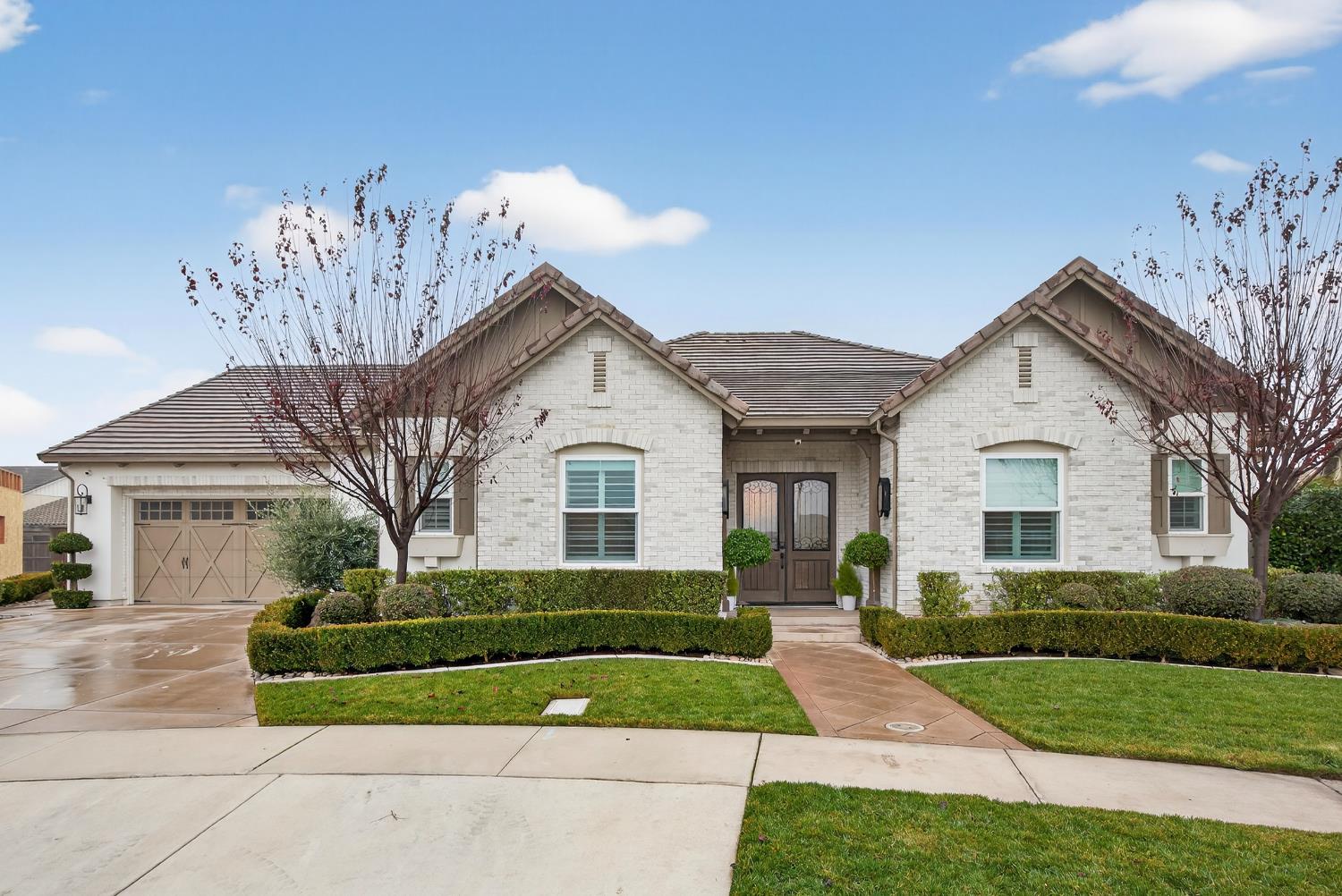 61 Secret Court Lodi, CA 95242 - Photo 78 of 79 a front view of a house with a yard and garage