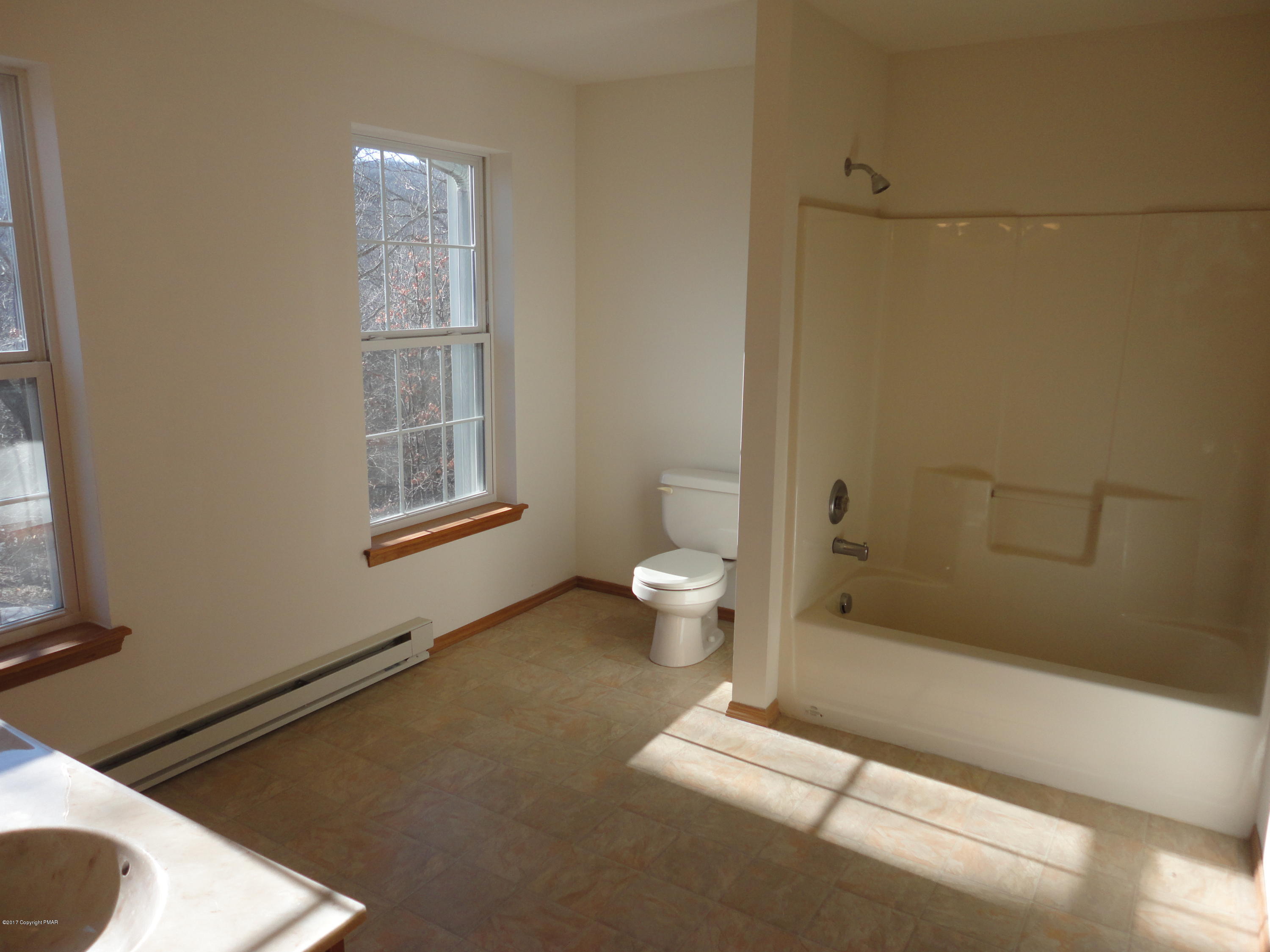 6389 Decker Road Bushkill, PA 18324 - Photo 12 of 22 a bathroom with a granite countertop sink a toilet and shower