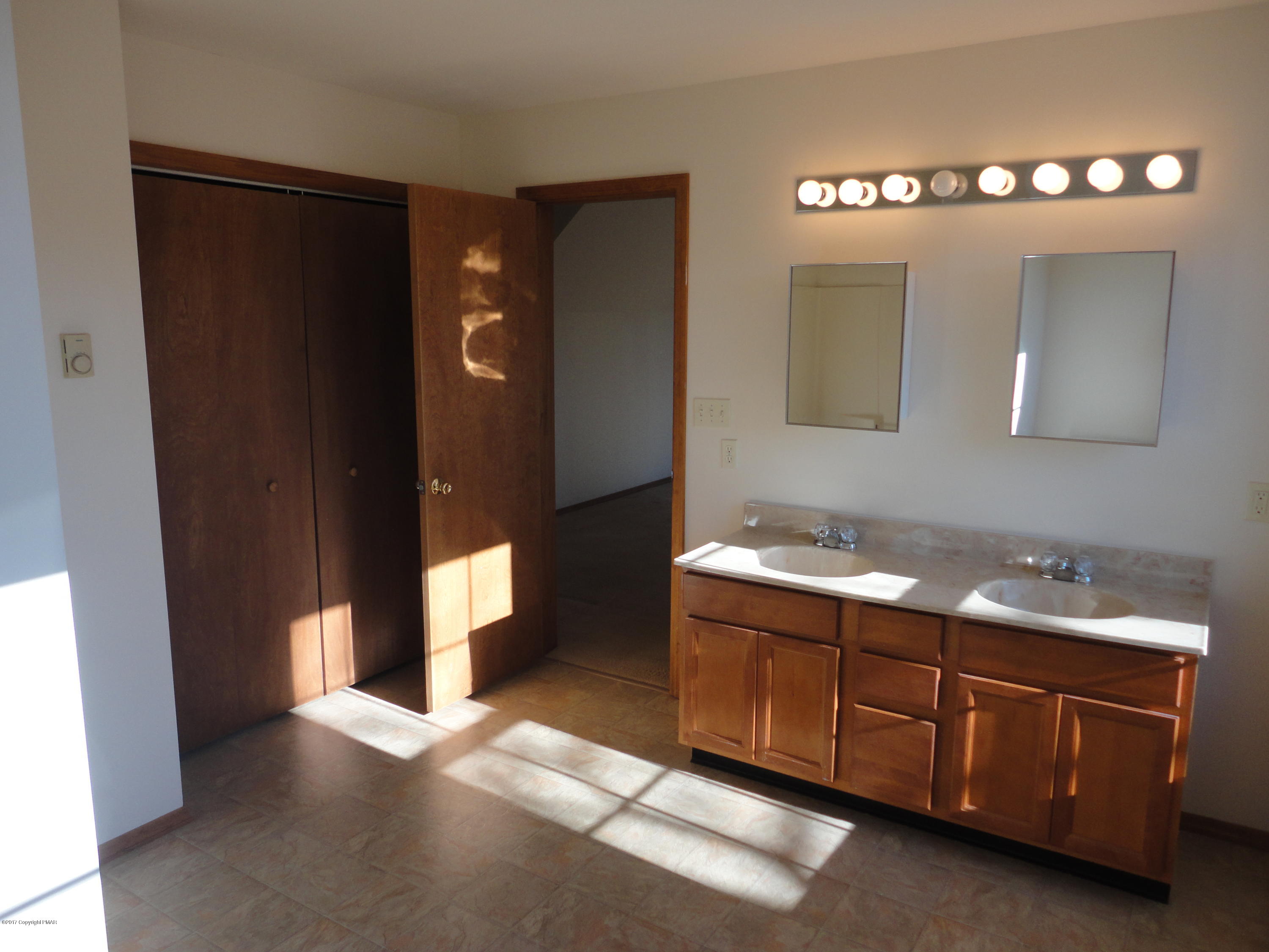 6389 Decker Road Bushkill, PA 18324 - Photo 13 of 22 a bathroom with a sink vanity and mirror
