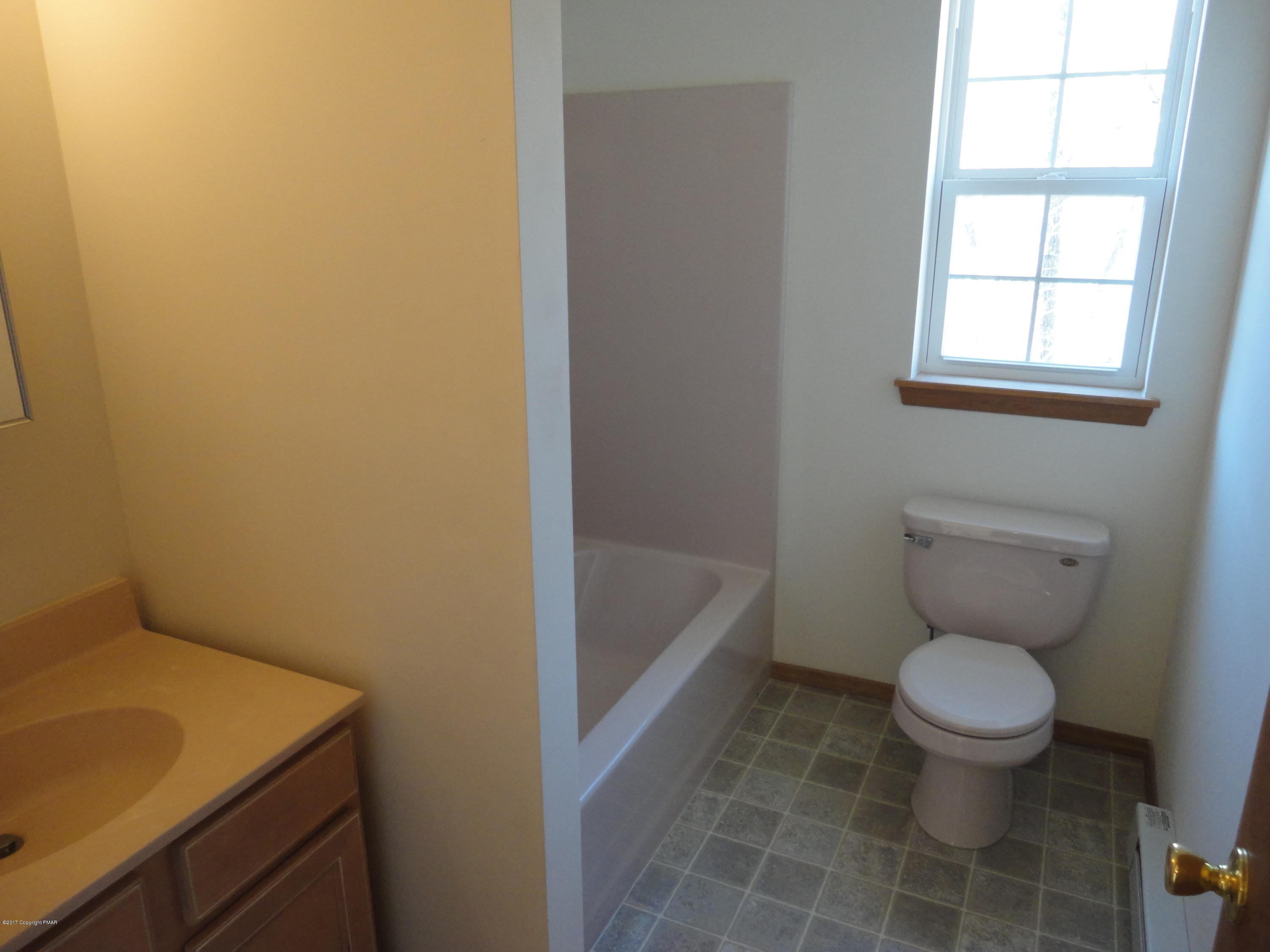 6389 Decker Road Bushkill, PA 18324 - Photo 14 of 22 a bathroom with a toilet and a sink
