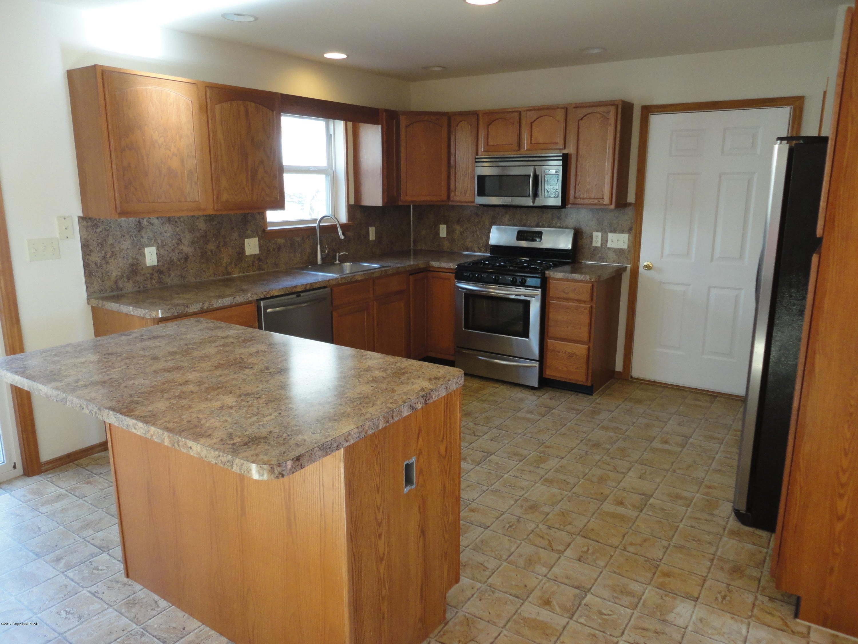 6389 Decker Road Bushkill, PA 18324 - Photo 2 of 22 a kitchen with stainless steel appliances granite countertop a sink a stove and a refrigerator