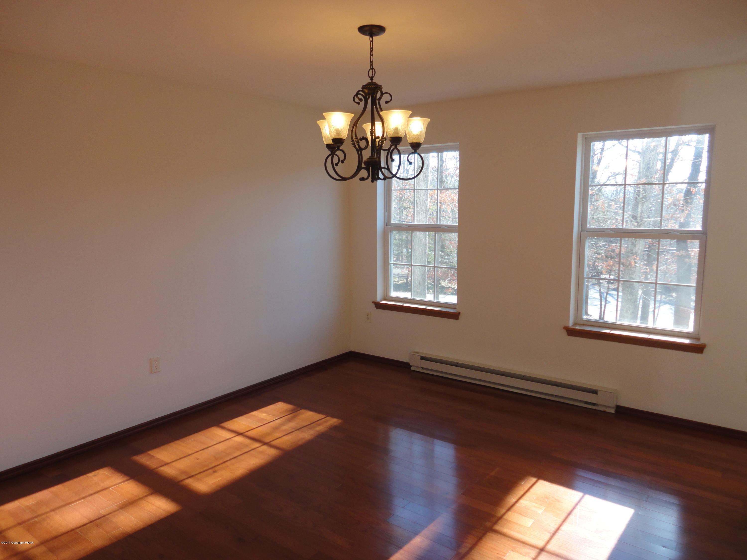 6389 Decker Road Bushkill, PA 18324 - Photo 4 of 22 a view of empty room with wooden floor and fan