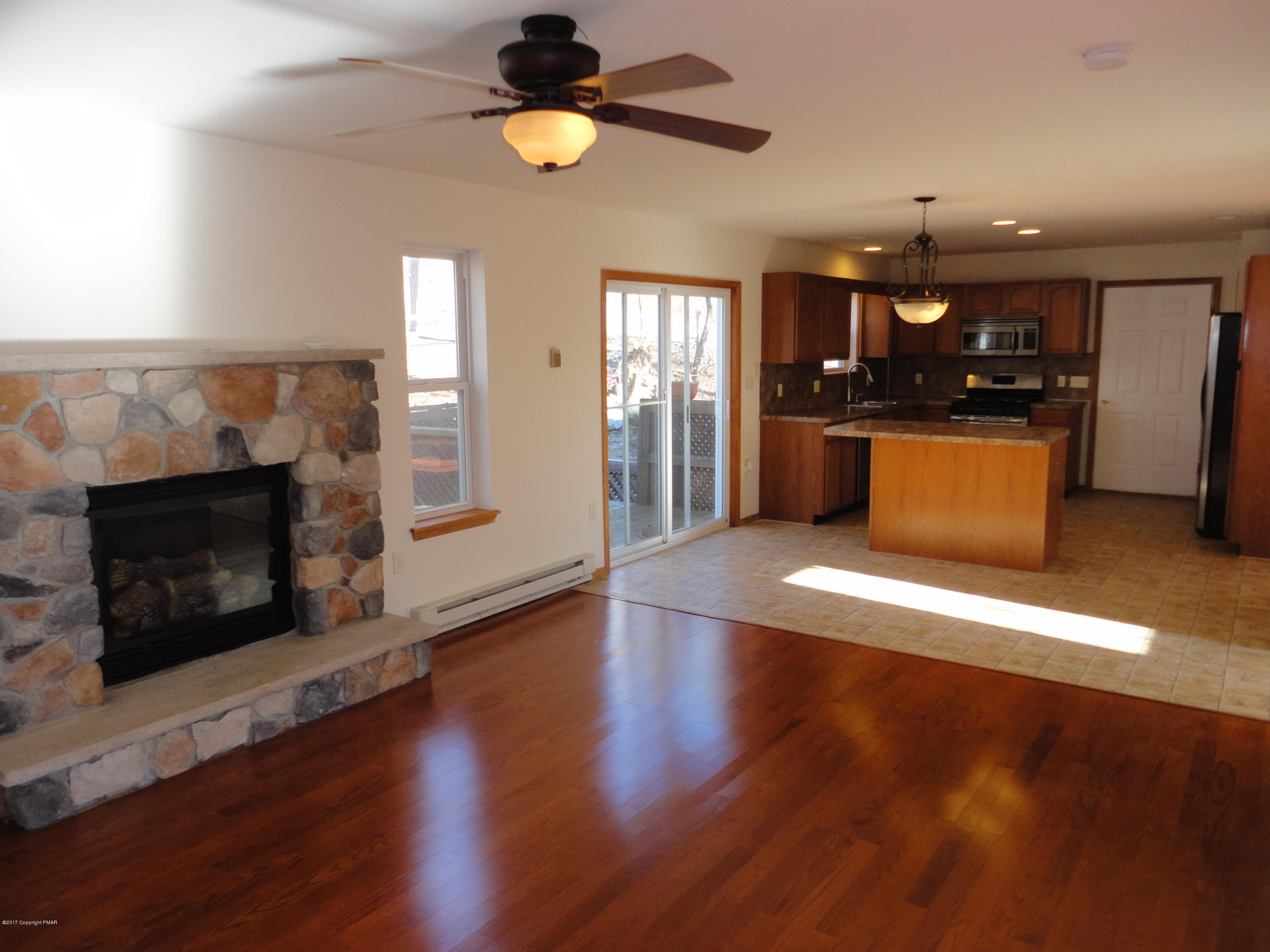 6389 Decker Road Bushkill, PA 18324 - Photo 22 of 22 an empty room with wooden floor and fireplace