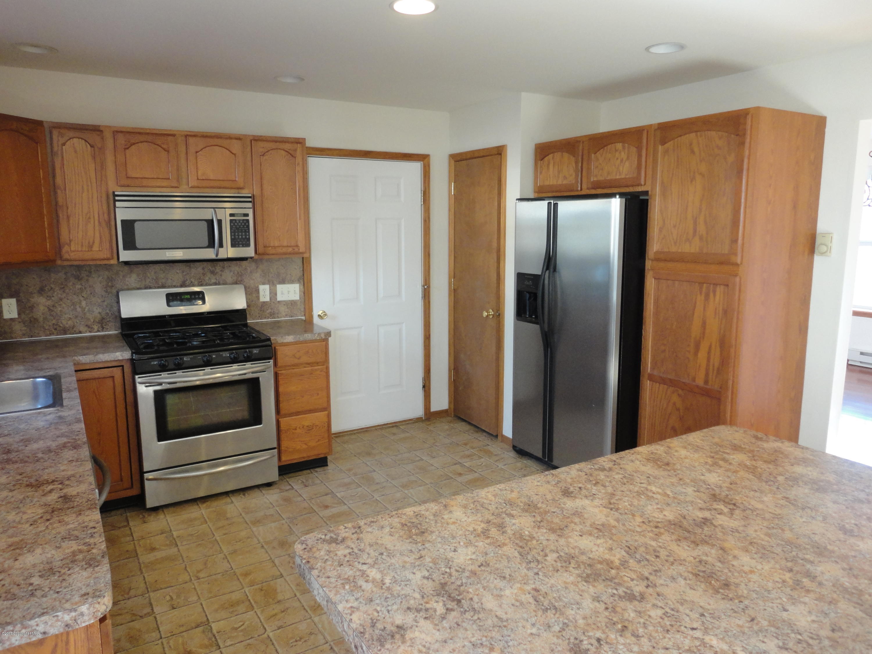 6389 Decker Road Bushkill, PA 18324 - Photo 7 of 22 a kitchen with stainless steel appliances granite countertop a refrigerator stove and microwave