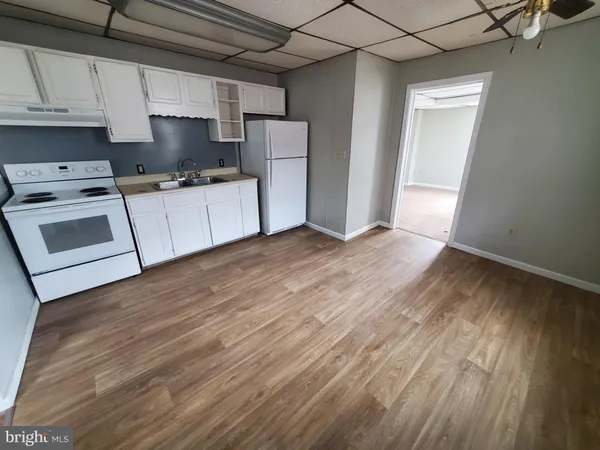 a kitchen with a refrigerator a stove top oven a sink and dishwasher