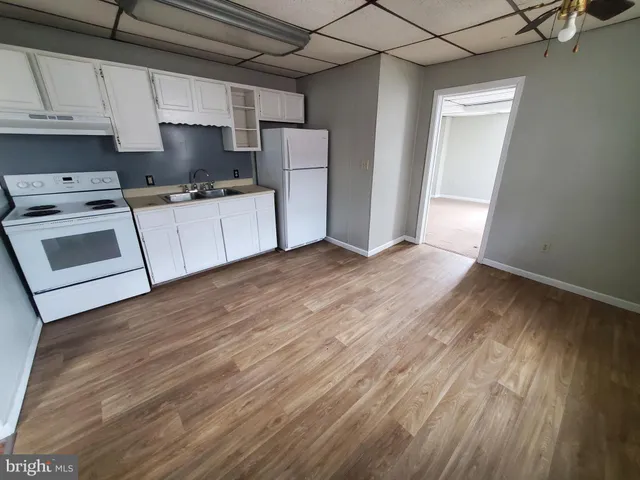 a kitchen with a refrigerator a stove top oven a sink and dishwasher