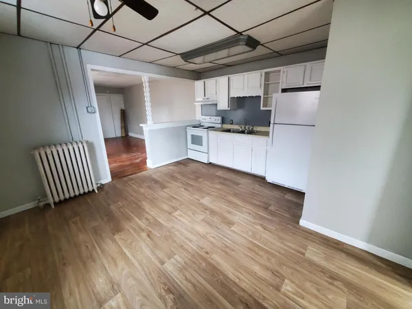 a kitchen with stainless steel appliances a refrigerator and a stove top oven