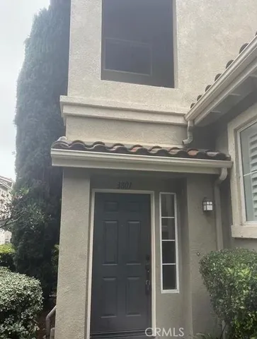 a view of a house with a window and potted plants