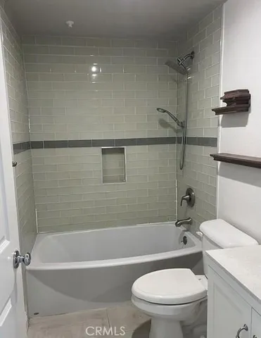 a bathroom with a toilet and a bath tub