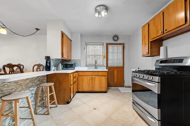 a kitchen with stainless steel appliances granite countertop a refrigerator and a sink